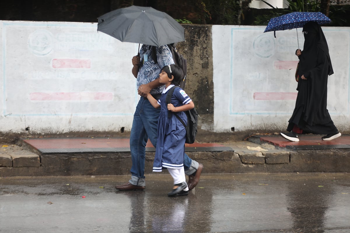 It has been raining daily in Sylhet. A father takes his child to school, carrying an umbrella in the rain. Shibganj, Sylhet, 5 April.