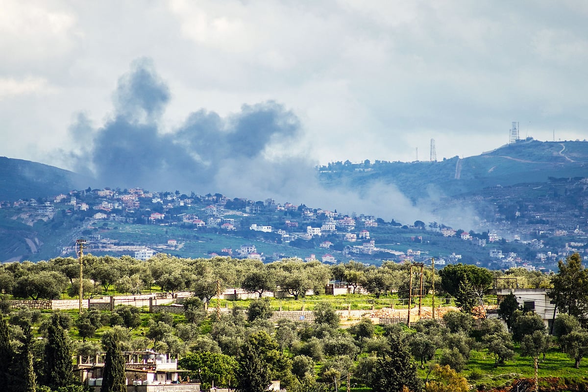 Smoke rises from the area of Houla caused by Israeli military activities as seen from the southern Lebanese city of Nabatieh on 7 April 2026