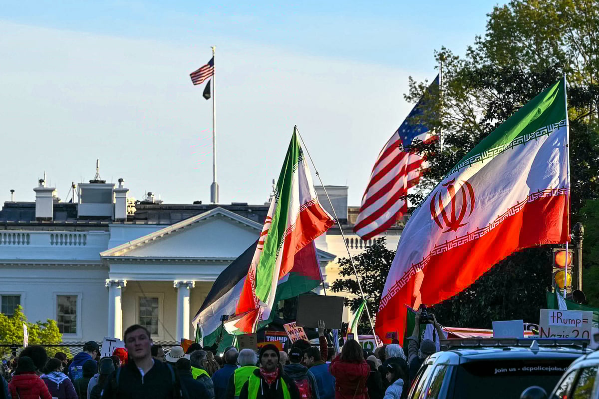 Demonstrators wave Iranian flags during a protest against US military action in Iran near the White House in Washington, DC, on 7 April, 2026.