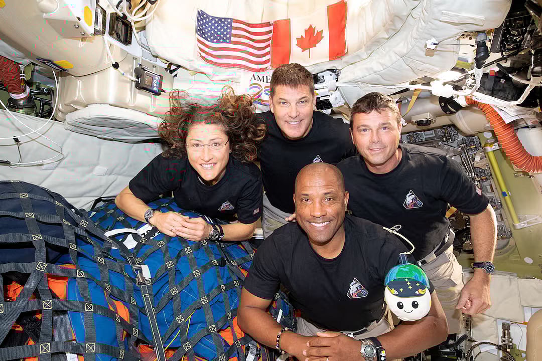 The NASA Artemis II crew, Mission Specialist Christina Koch, Mission Specialist Jeremy Hansen, Commander Reid Wiseman, and Pilot Victor Glover, pose for a group photo inside the Orion spacecraft on their way home following a flyby of the far side of the Moon on 6 April, 2026.