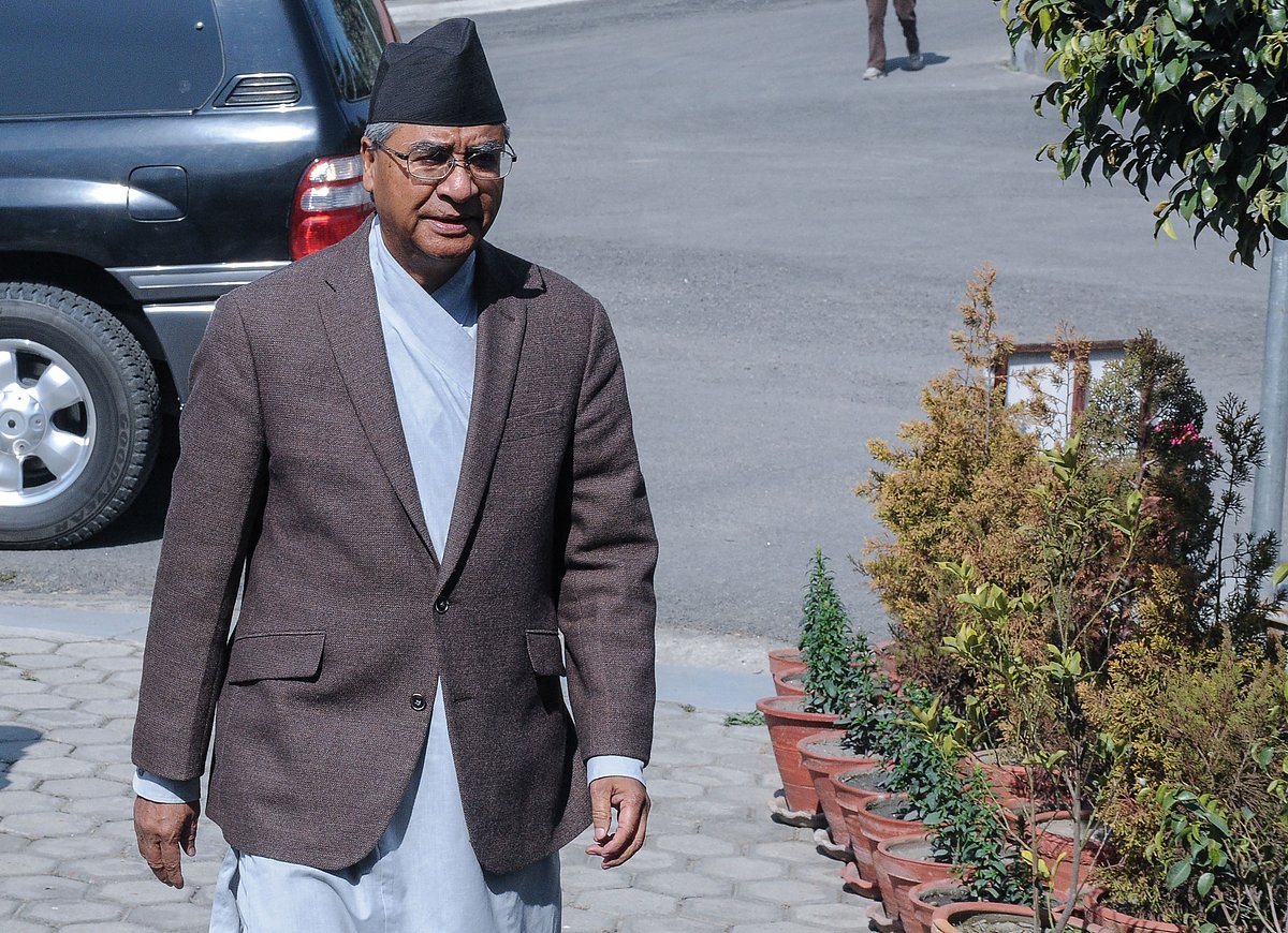 Nepali Prime Minister Sher Bahadur Deuba (former) arrives for his address to the nation before submitting his resignation to the president at his official residence in Baluwatar in Kathmandu on February 15, 2018. Nepal has issued an arrest warrant for former prime minister Sher Bahadur Deuba for alleged corruption, officials said on April 9, 2026 making him the latest high-profile figure targeted under the new government.