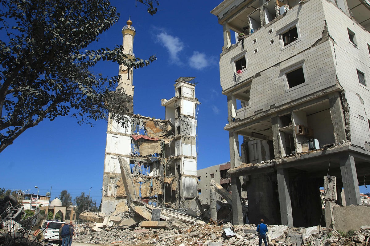People inspect the site of an Israeli airstrike that targeted a religious Shiite complex the day before in the southern Lebanese coastal city of Sidon on April 9, 2026.