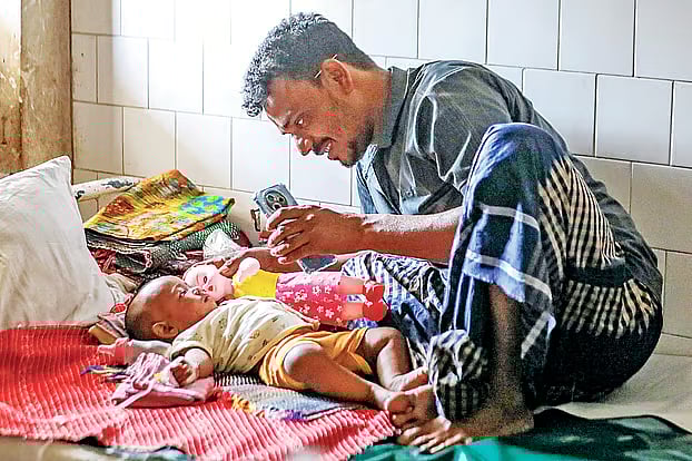 Seven-month-old Sajeeb Mia admitted to hospital; his father shows him to a relative over a video call. Infectious Diseases Hospital, Mohakhali, Dhaka. 