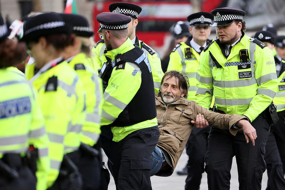 Police officers detain a protester at 'Everyone Day', a mass vigil and sign-holding event in Trafalgar Square organised by Defend Our Juries to demand the lifting of the ban on Palestine Action, in London, Britain, 11 April, 2026.