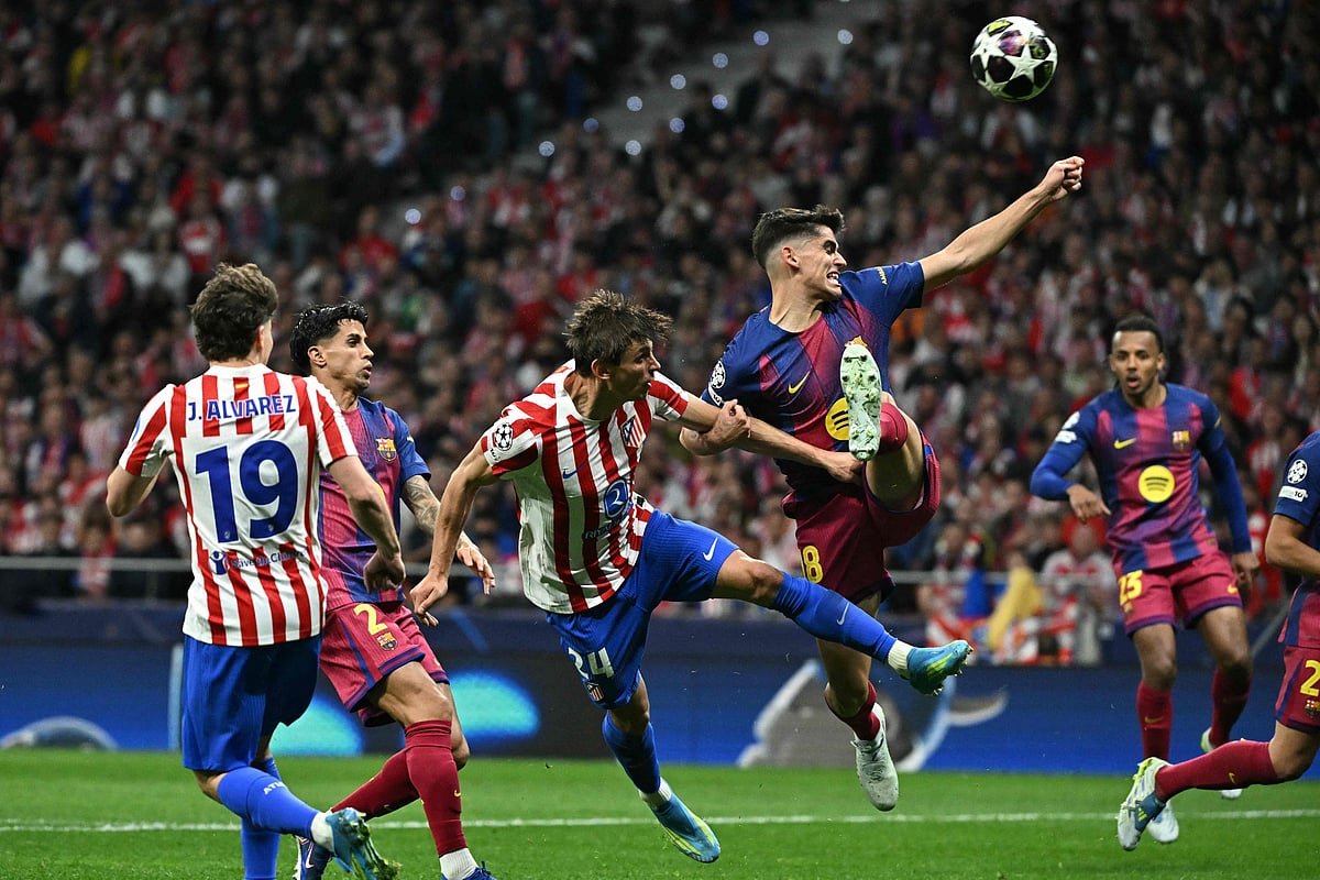 Atletico Madrid’s Spanish defender #24 Robin Le Normand (C) vies for the ball with Barcelona’s Spanish defender #18 Gerard Martin during the UEFA Champions League quarter final second leg football match between Club Atletico de Madrid and FC Barcelona at Metropolitano Stadium in Madrid on 14 April 2026