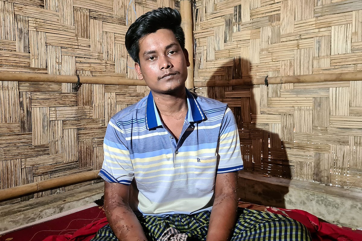 A survivor of a boat capsize sits inside his shelter at a refugee camp in Ukhia, in Bangladesh’s Cox’s Bazar on 15 April 2026
