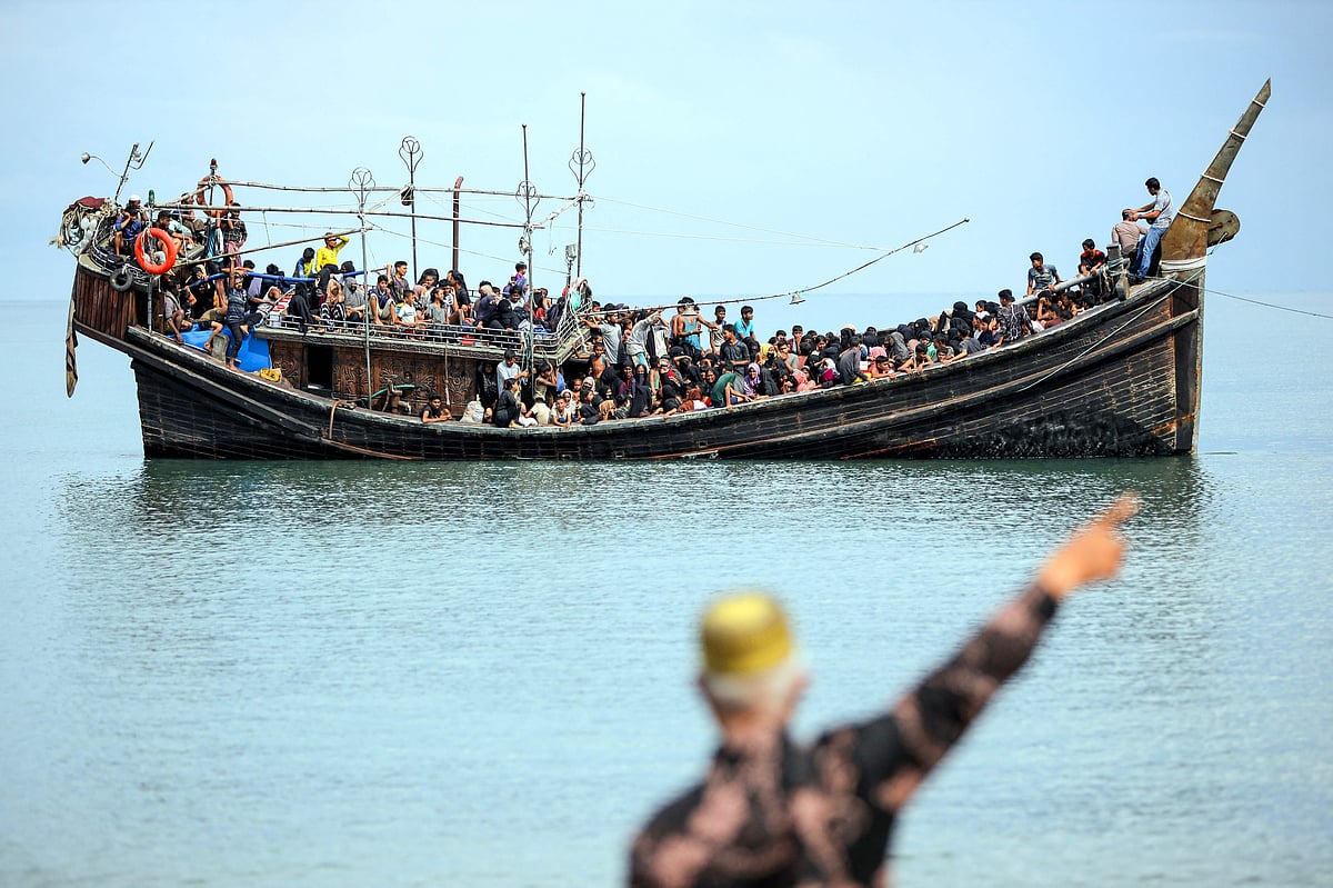 Newly arrived Rohingya refugees are stranded on a boat after the nearby community decided not to allow them to land after giving them water and food in Pineung, Aceh province on 16 November 2023