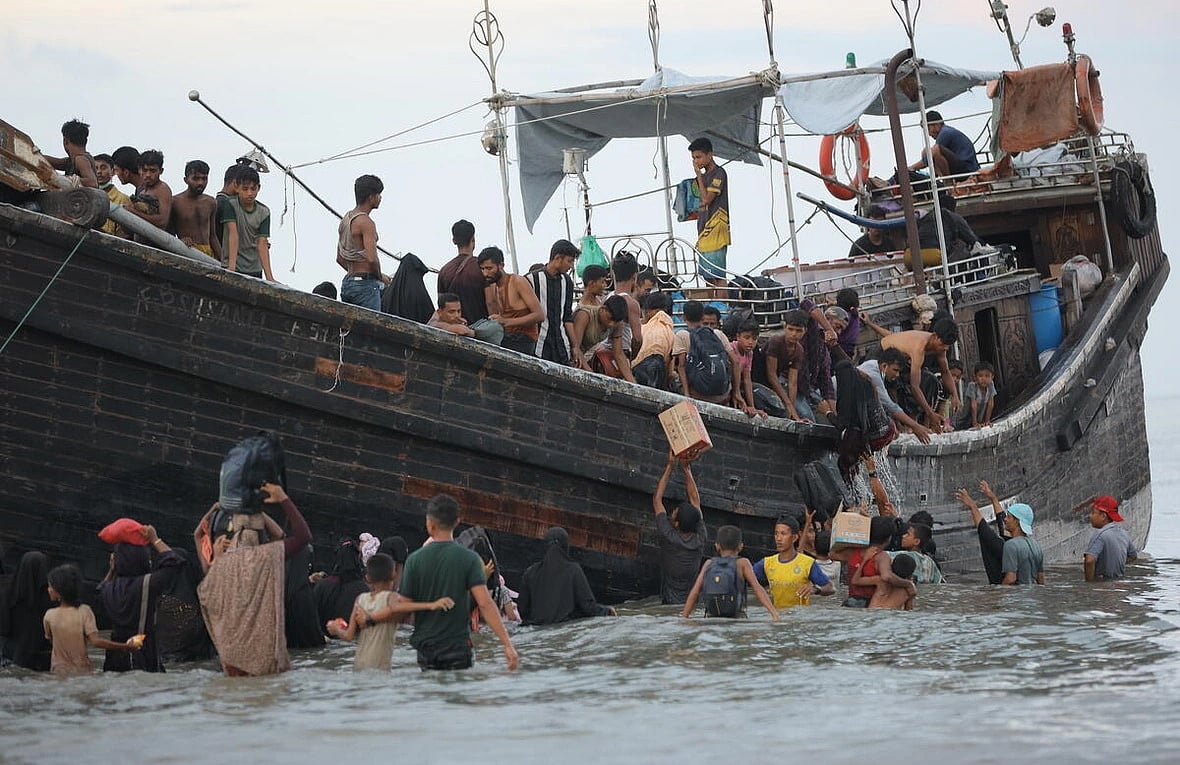Rohingya refugees disembark from a vessel in Ulee Madon, in Indonesia's North Aceh, in November 2023.