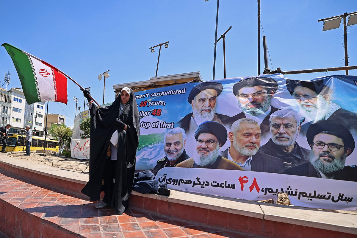 A woman waves Iran's national flag at the Revolution Square in Tehran on April 12, 2026.