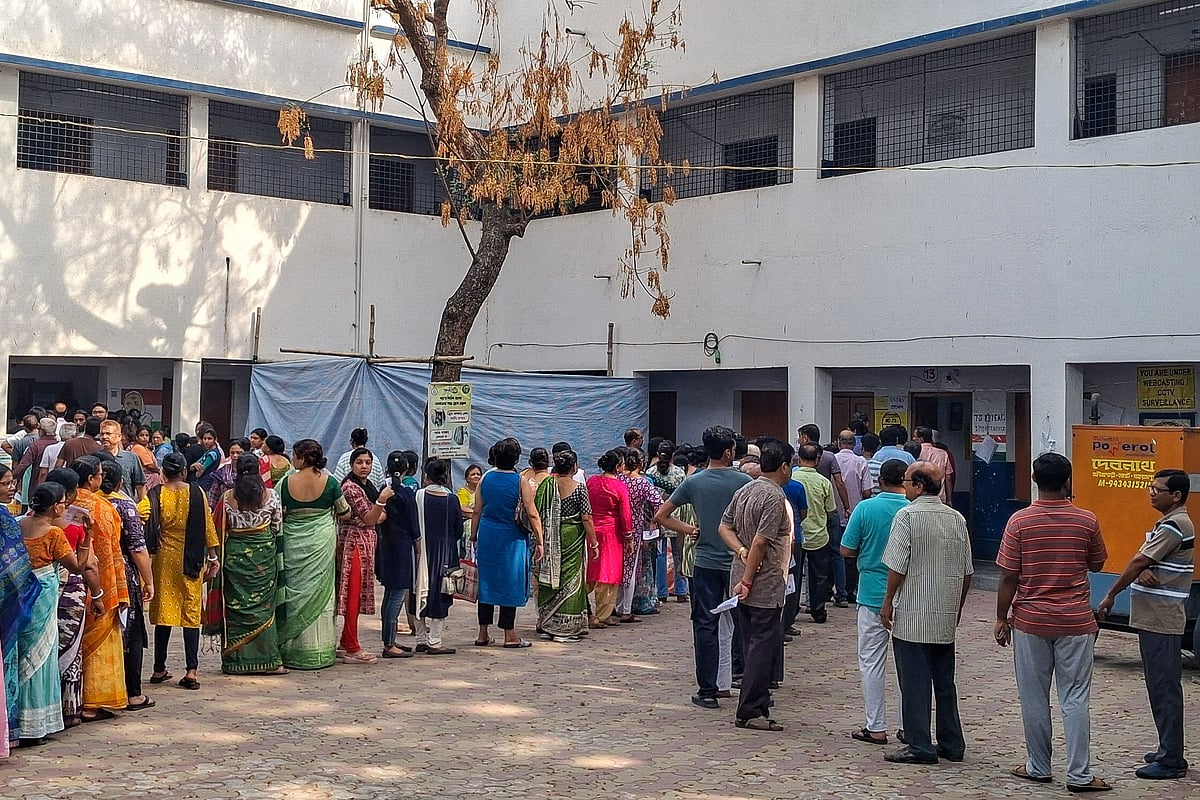 Voters queue up to cast their votes outside a polling station during the West Bengal Legislative Assembly elections in Berhampore, Murshidabad district, on 23 April 2026