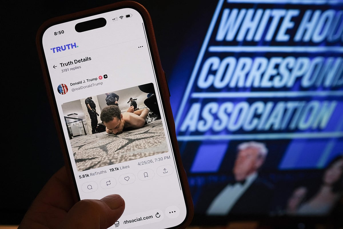 This illustration photo taken in Los Angeles shows a phone with a Truth Social post by US President Donald Trump displaying an image of the alleged suspect in a shooting incident at the White House Correspondents’ Dinner on the ground after being apprehended on April 25, 2026