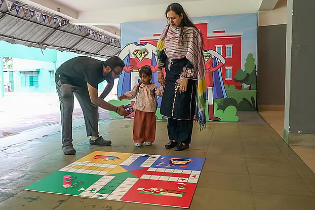 A family has arrived at the ''English Medium School Admission Fair 2026'' organized by the British Council and Prothom Alo Dotcom. 2 May 2026; Gulshan Shooting Club, Dhaka.