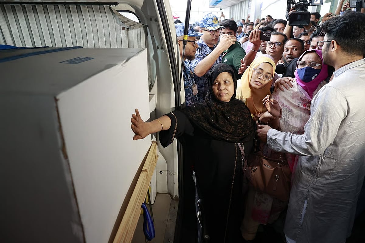 Zamil Ahmed Limon had gone abroad to pursue a PhD; he returned as a body. Relatives try to touch him one last time.