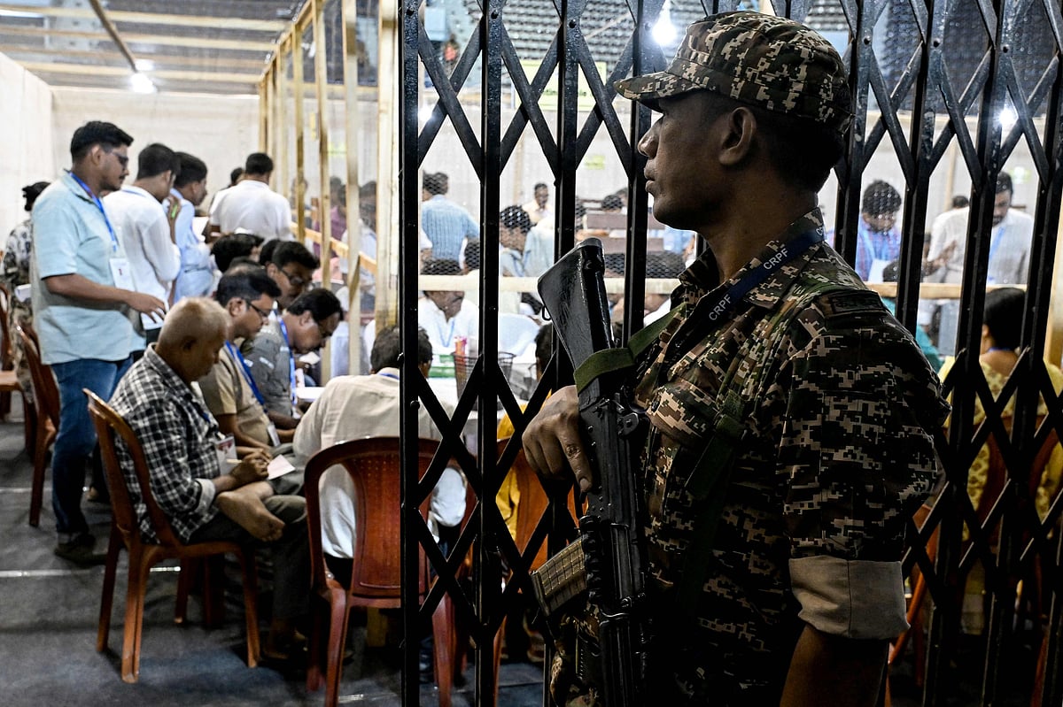 A Central Reserve Police Force (CRPF) personnel stands guard as election officials count votes after the West Bengal Legislative Assembly elections at the Netaji Indoor Stadium in Kolkata on 4 May, 2026.