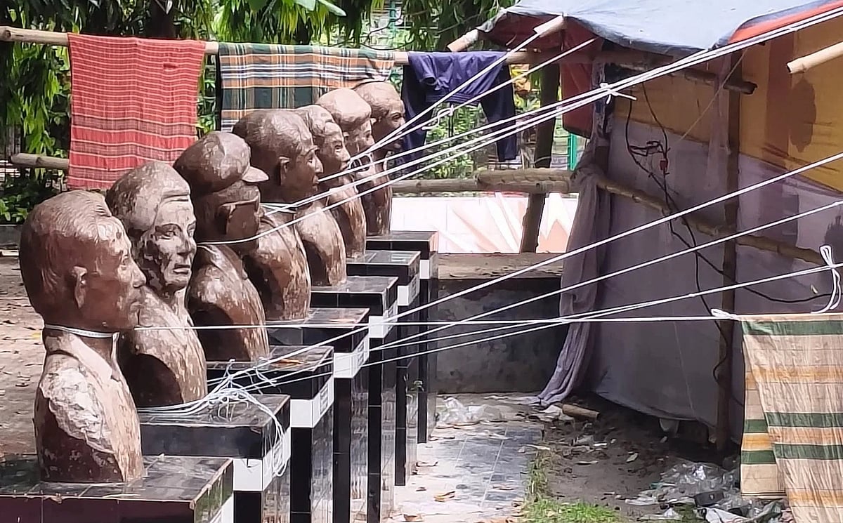 The ropes of the stalls set up at the BSCIC fair at the Tangail Shaheed Smrity Pouro Udyan are tied around the necks of the sculptures of the seven Bir Sreshtho.