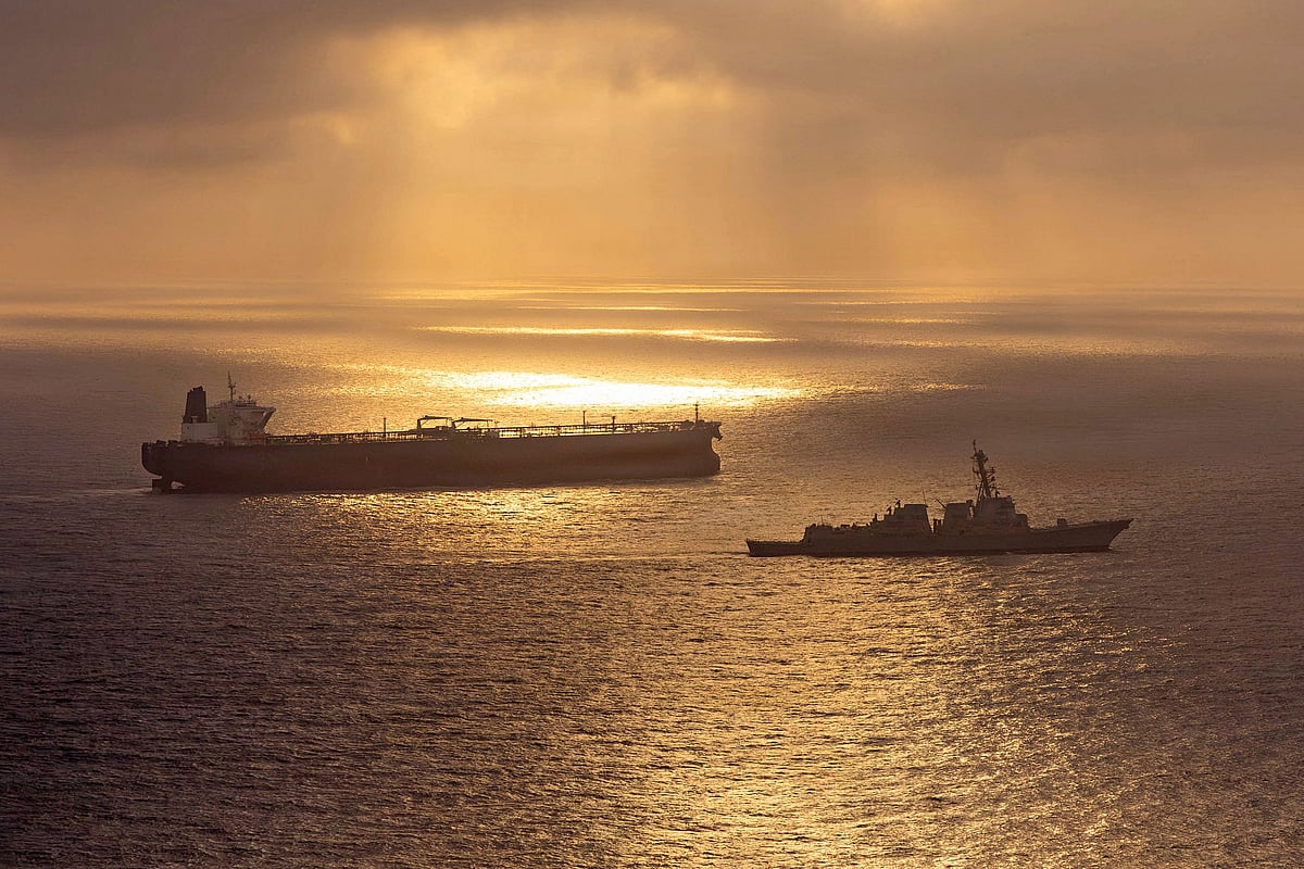 This US Navy handout photo released on 8 May, 2026 by US Central Command Public Affairs, shows the Arleigh Burke-class guided-missile destroyer USS Rafael Peralta (DDG 115) implementing a maritime blockade against the Iran-flagged crude oil tanker vessel Herby while the latter was attempting to sail toward an Iranian port, on 24 April, 2026. The war launched by the US and Israel in late February saw Iran respond with attacks across the Middle East and maintain a stranglehold on the Strait of Hormuz, choking off major flows of oil, gas, and fertilizer to the world economy, while the US has imposed a counter-blockade on Iranian ports.