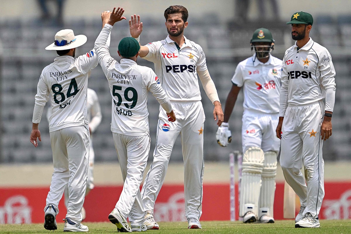 Pakistan's Shaheen Shah Afridi (C) celebrates with teammates after taking the wicket of Bangladesh's Mushfiqur Rahim during the second day of the first test cricket match between Bangladesh and Pakistan at the Sher-e-Bangla National Stadium in Mirpur on May 9, 2026