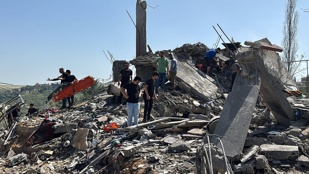 Emergency responders assisted by other people and heavy machinery inspect the site of an Israeli strike in Saksakiyeh, Lebanon, 9 May, 2026. Picture taken with a mobile phone.