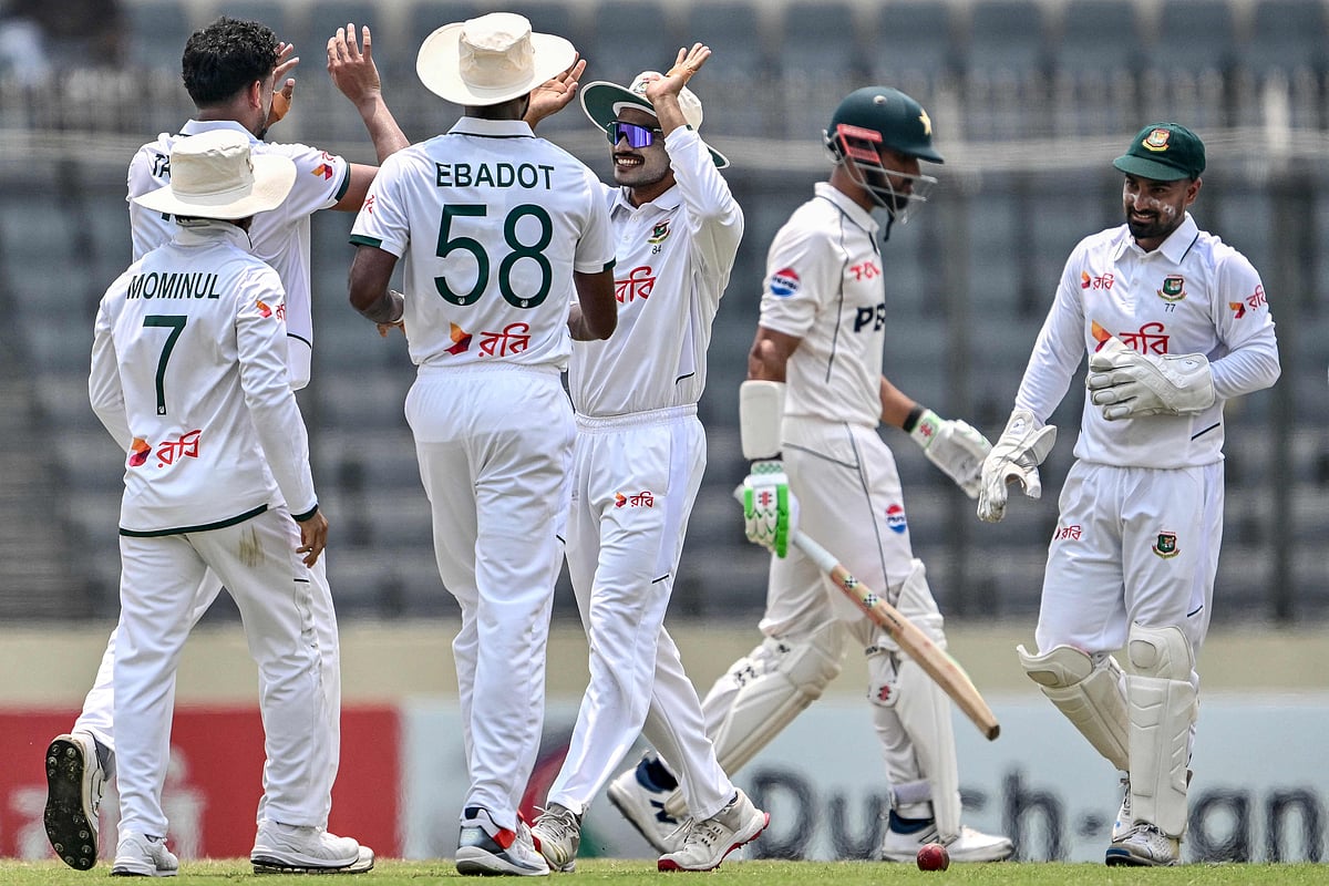 Bangladesh's captain Najmul Hossain Shanto (C) celebrates with teammates after the dismissal of Pakistan's captain Shan Masood (2R) during the third day of the first Test cricket match between Bangladesh and Pakistan at the Sher-e-Bangla National Stadium in Mirpur on May 10, 2026. (Photo by Munir UZ ZAMAN / AFP)
