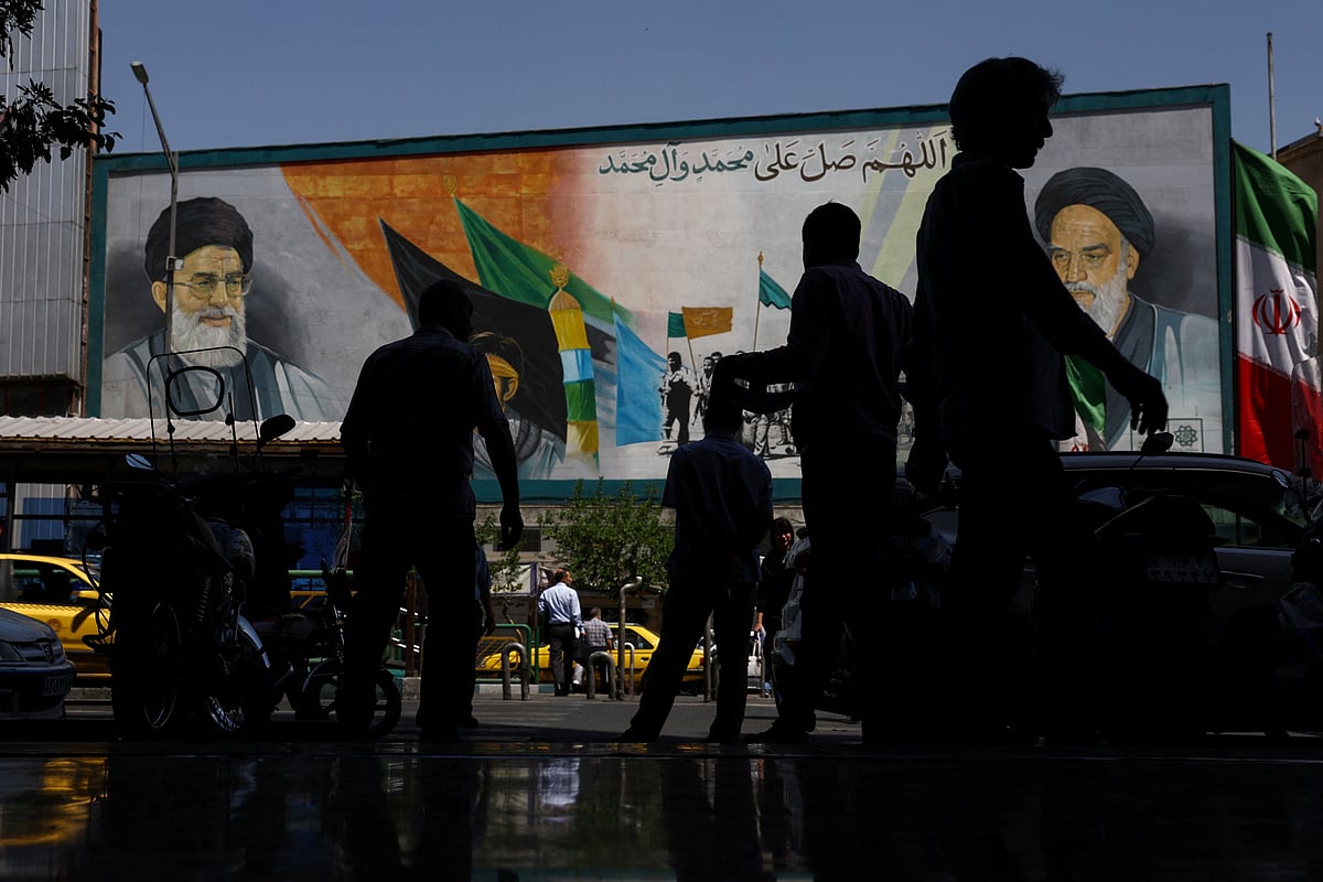People walk past a mural depicting the late leader of the Islamic Revolution, Ayatollah Ruhollah Khomeini, and the late Iran's Supreme Leader Ayatollah Ali Khamenei, in Tehran, Iran, 12 May, 2026.