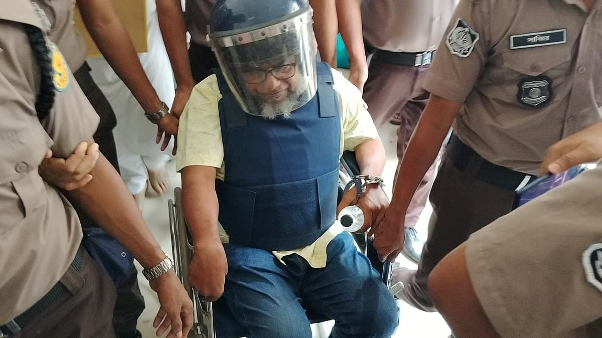 Police escort former Home Secretary Jahangir Alam in a wheelchair to the Dhaka Metropolitan Magistrate’s Court on 13 May 2026.