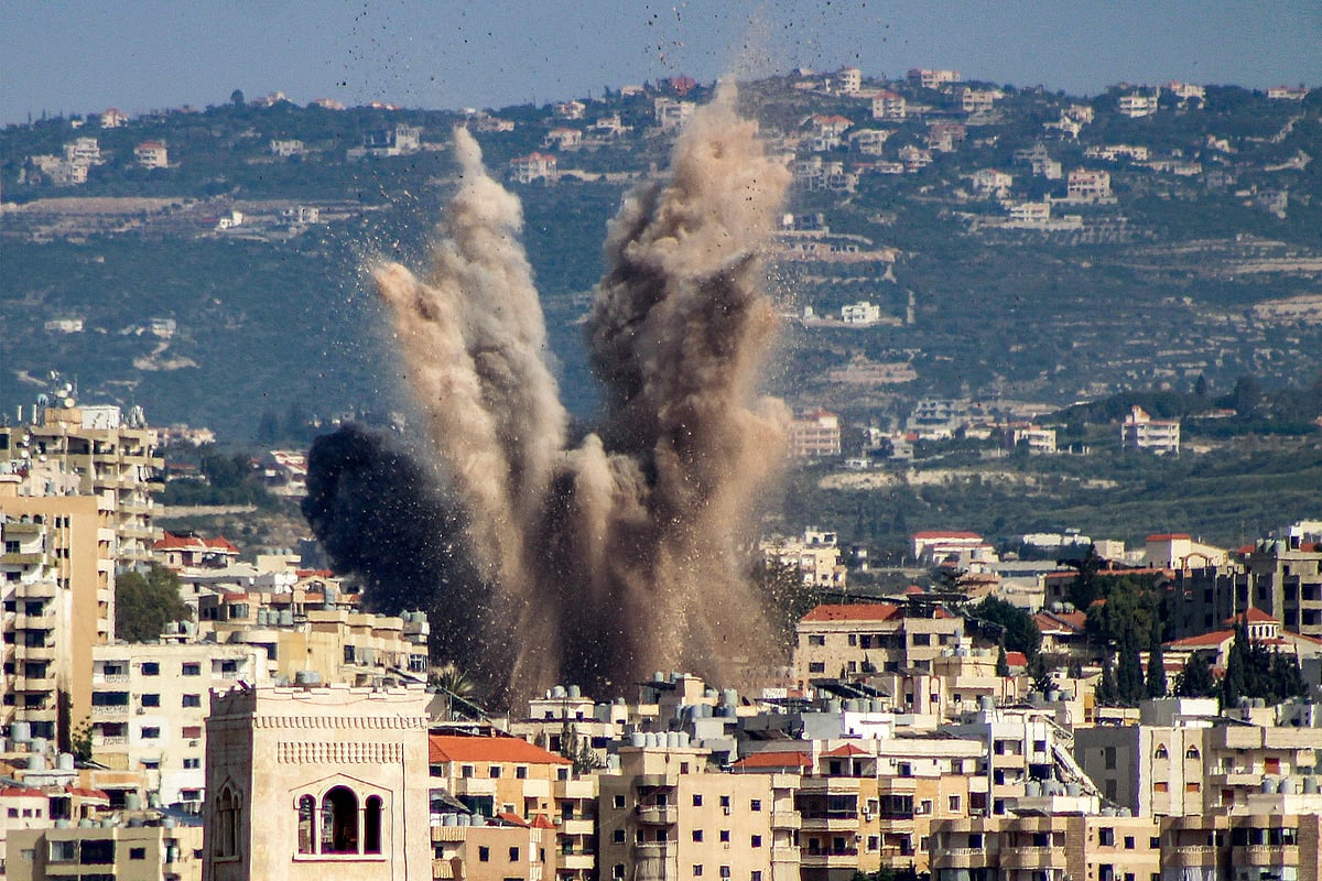 An explosion erupts in the area of al-Housh following Israeli bombardment as seen from Tyre in southern Lebanon on 12 May, 2026.