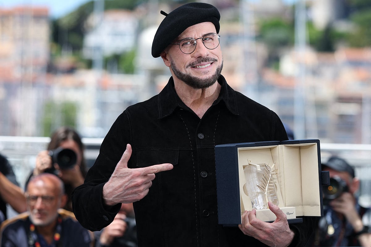 US director, screenwriter and writer John Travolta poses with an honourary lifetime achievement Palm d'Or award during a photocall of the film "Vol de nuit pour Los Angeles" (Propeller One-Way Night Coach) at the 79th edition of the Cannes Film Festival in Cannes, southern France on 16 May, 2026.