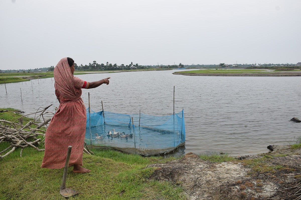 Marjina Khatun points to show her agricultural land which was lost in the impact of Cyclone Amphan. Photo taken from Katmar Char area of Koyra upazila of Khulna district. 