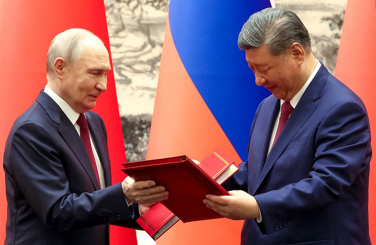Russia's President Vladimir Putin and China's President Xi Jinping exchange documents during a signing ceremony following their talks in Beijing on 20 May 2026.