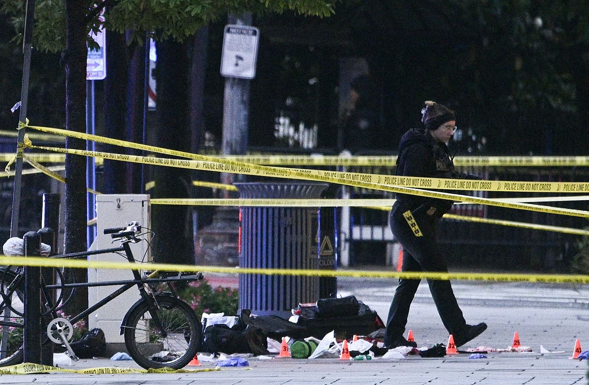 Police tape blocks off a crime scene with evidence markers seen on a sidewalk on 17th and Pennsylvania Ave near the White House in Washington, DC, on May 23, 2026. Police and security forces swarmed the area around the White House on the evening of May 23 after reports of shots fired, AFP journalists said. US President Donald Trump was at the White House at the time as he worked to negotiate a deal with Iran. (Photo by Brendan SMIALOWSKI / AFP)
