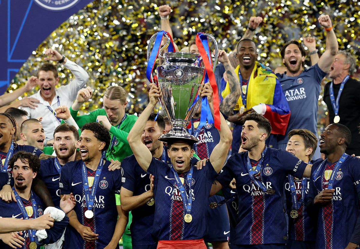 Paris St Germain's Achraf Hakimi with the trophy as he celebrates with players after winning the UEFA Champions League Final at Puskas Arena, Budapest, Hungary on 30 May 2026.
