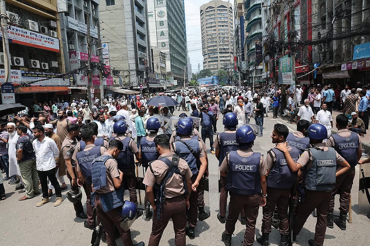 Police maintain a heightened security presence in front of Islami Bank’s head office.