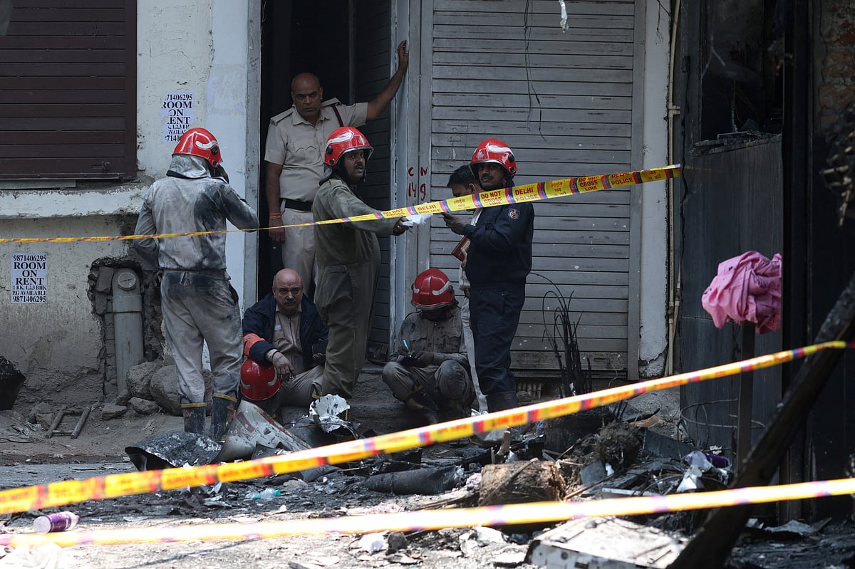 Firefighters work at the site after a fire at a hotel in New Delhi, India, 3 June 2026.