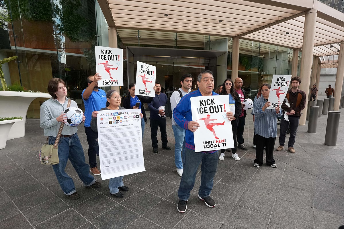 Sofi Stadium worker Alex Mejia speaks at Immigrant rights advocates and labor groups protest outside the FIFA Los Angeles World Cup 2026 Host Committee offices for changes to worker credential policies that they say could expose stadium workers and immigrant communities to immigration enforcement during the World Cup.
