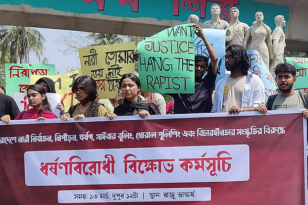 Students and activists stage a protest at the foot of the Raju Memorial Sculpture at the University of Dhaka against violence against women, abuse, rape, cyberbullying, and the culture of impunity. 