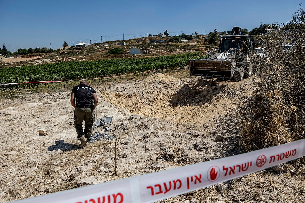 An Israeli security personnel inspects an impact site, after Iran launched missiles towards Israel, in an Israeli settlement in the Israeli-occupied West Bank, on 8 June 2026
