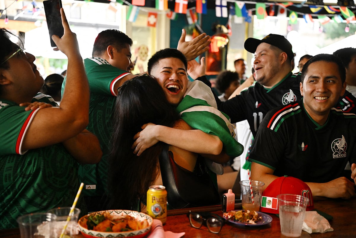 Mexico fans in New York celebrate after Mexico's Raul Jimenez scores their second goal