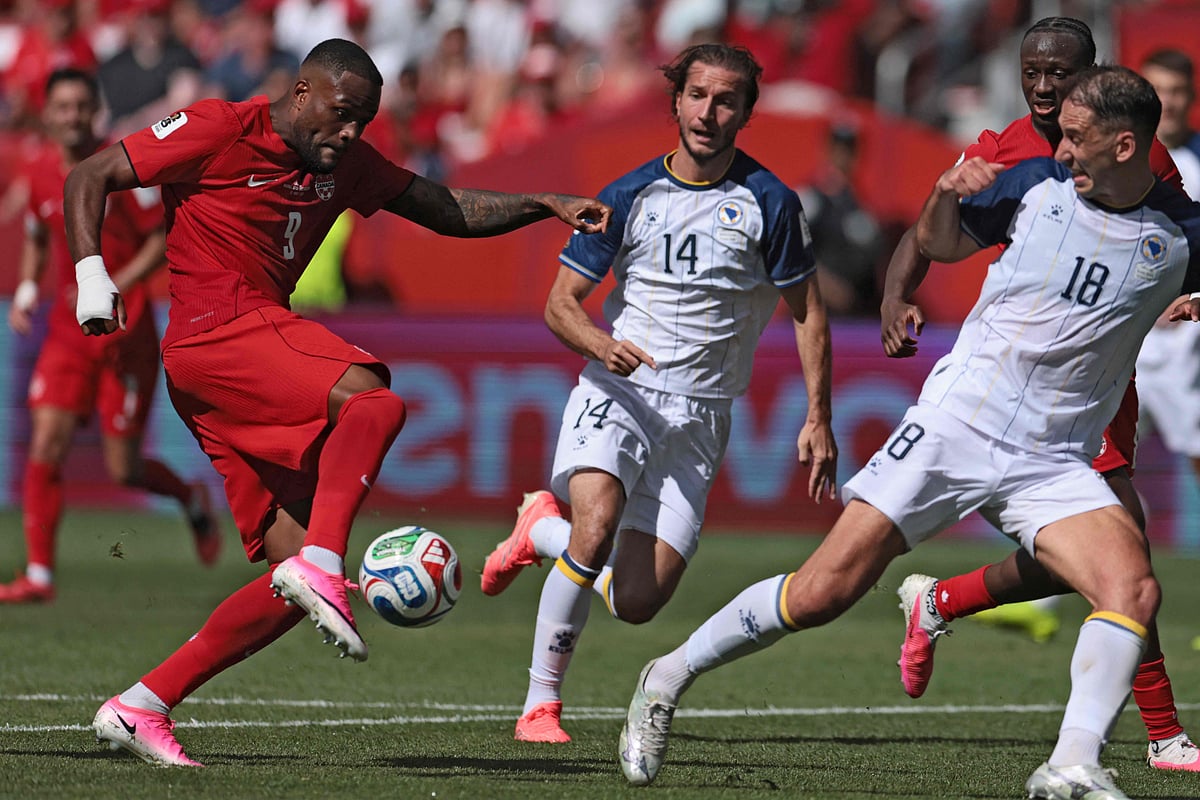 Canada's forward #09 Cyle Larin (L) scores the equalizer during the 2026 World Cup Group B football match between Canada and Bosnia and Herzegovina at the Toronto Stadium in Toronto on 12 June 2026.