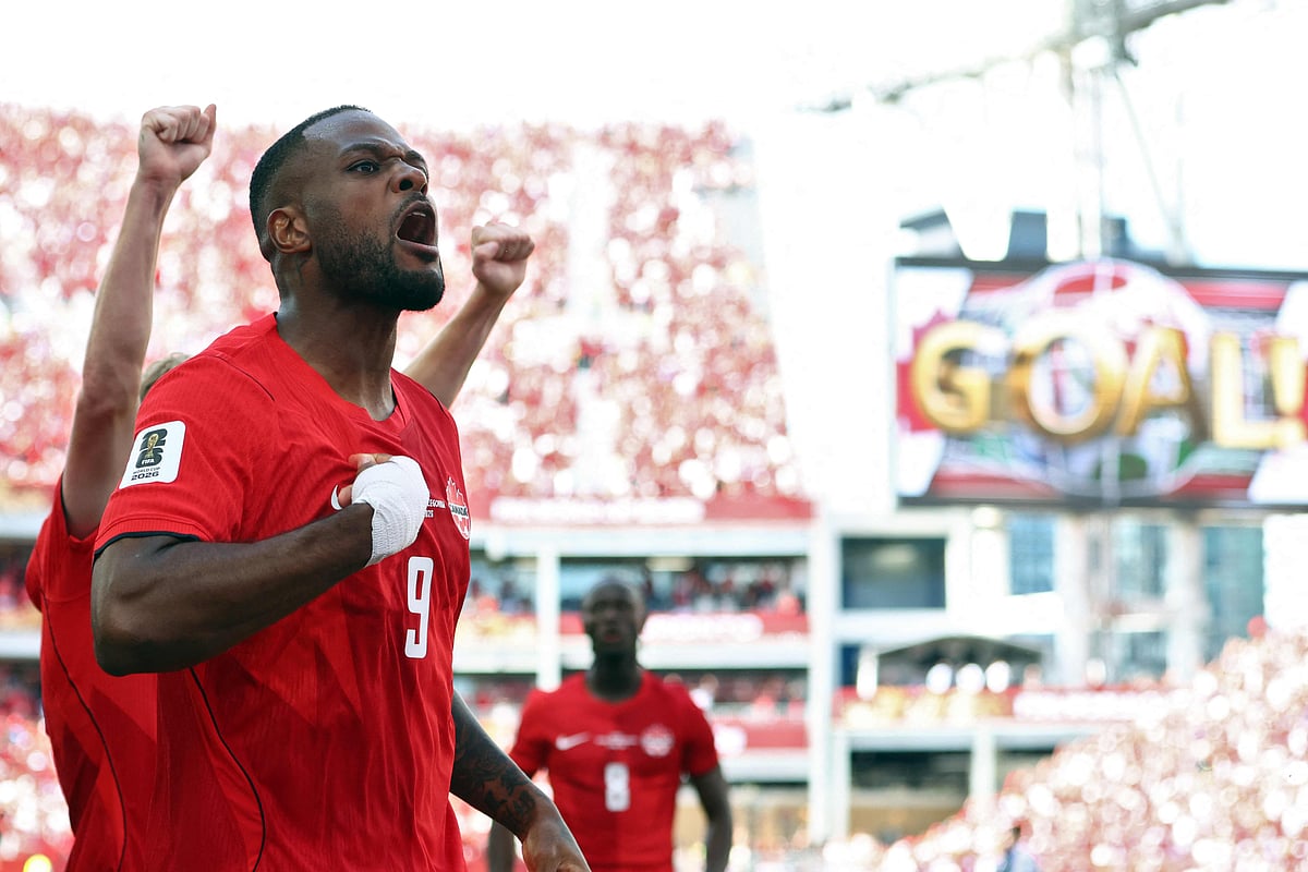 Canada's forward #09 Cyle Larin (R) celebrates after scoring a goal during the 2026 World Cup Group B football match between Canada and Bosnia and Herzegovina at the Toronto Stadium in Toronto on June 12, 2026.
