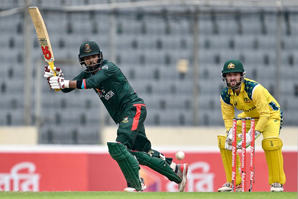 Bangladesh’s Towhid Hridoy (L) watches the ball after playing a shot as Australia’s wicketkeeper and captain Josh Inglis looks on during the third one-day international (ODI) cricket match between Bangladesh and Australia at the Sher-e-Bangla National Stadium in Dhaka on 14 June 2026