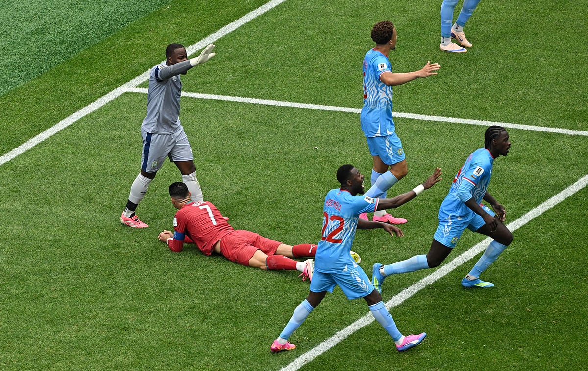 Football - FIFA World Cup 2026 - Group K - Portugal v DR Congo - Houston Stadium, Houston, Texas, U.S. - June 17, 2026
Portugal's Cristiano Ronaldo and DR Congo's Lionel Mpasi and teammates react