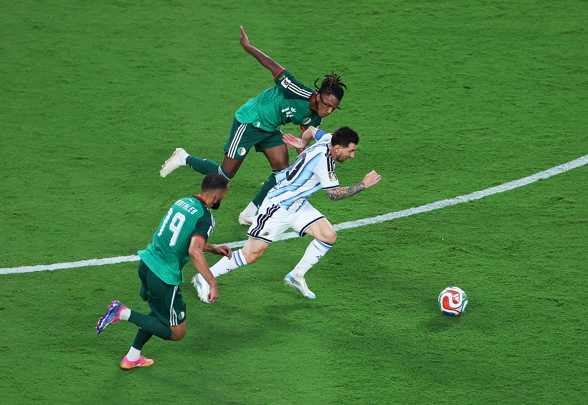 Argentina's Lionel Messi in action with Algeria's Hicham Boudaoui and Nabil Bentaleb