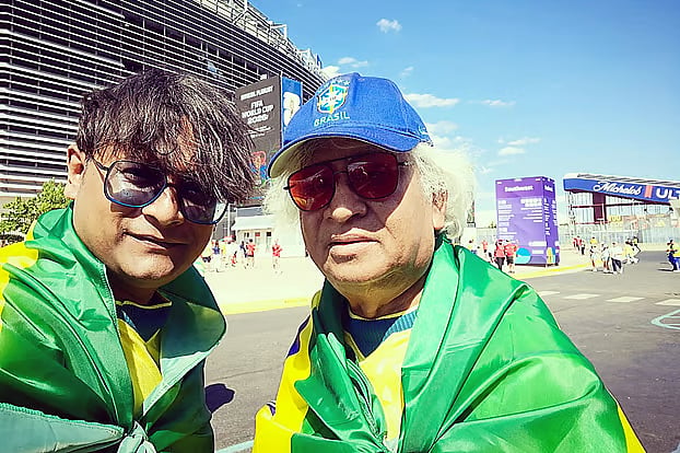 Father and son at the stadium watching Brazil’s first match.