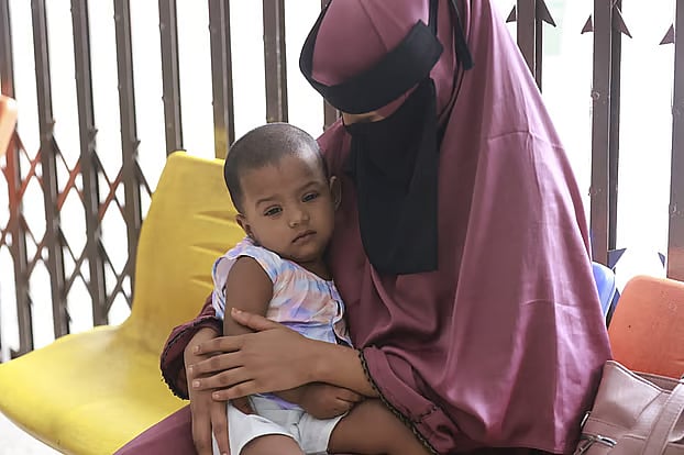 A child arrives for treatment at the COVID-19 Dedicated Hospital operated by the Dhaka North City Corporation (DNCC).