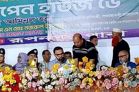 Ali Ahmed (standing in front), who is wanted in an embezzlement case, is seen on stage at an ‘Open House Day’ programme organised by Rupnagar Police Station at Rupnagar Field in Dhaka on 28 April.