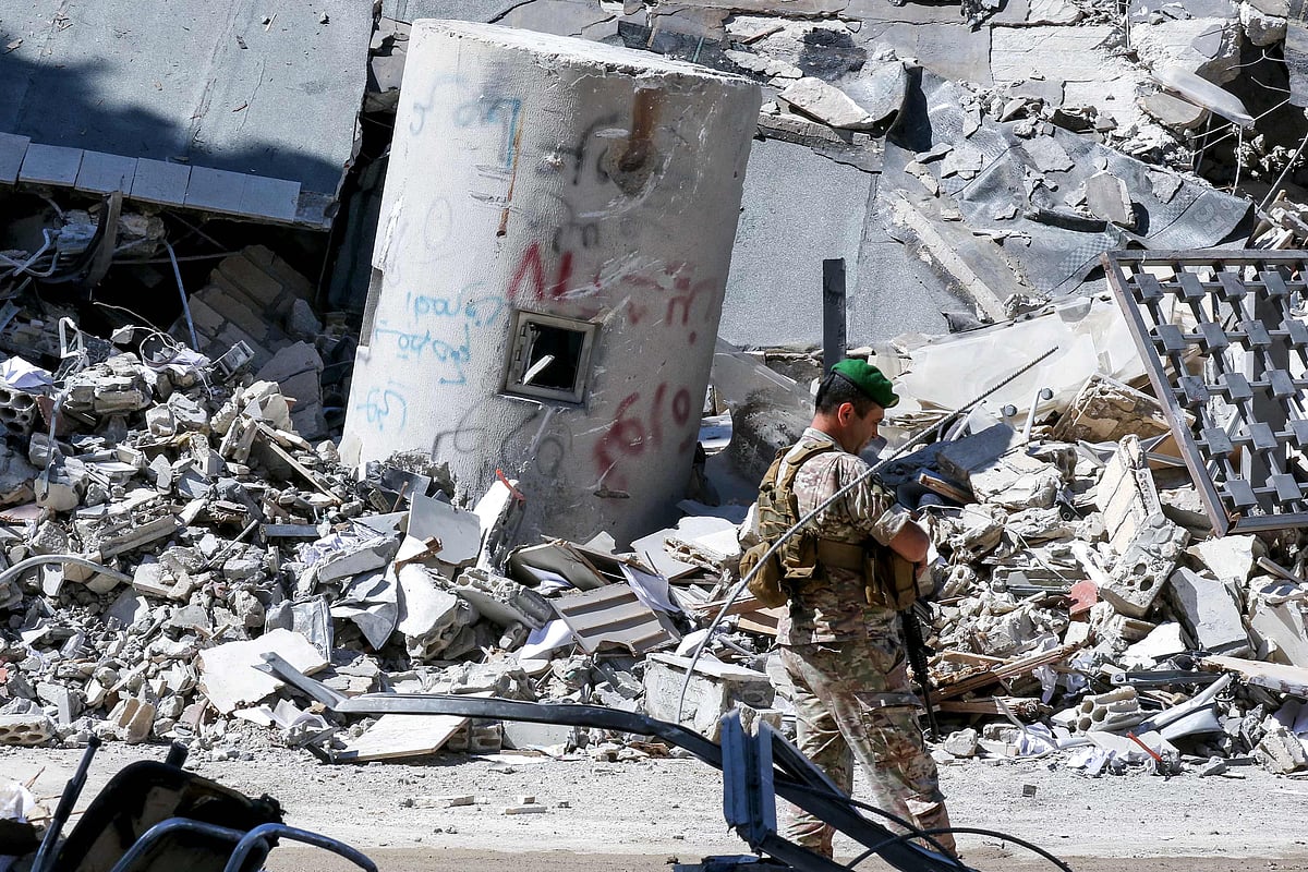 A Lebanese army soldier walks past the rubble of the local branch of the Banque du Liban, Lebanon's Central Bank, following Israeli bombardment, in Nabatieh in southern Lebanon on 21 June, 2026.