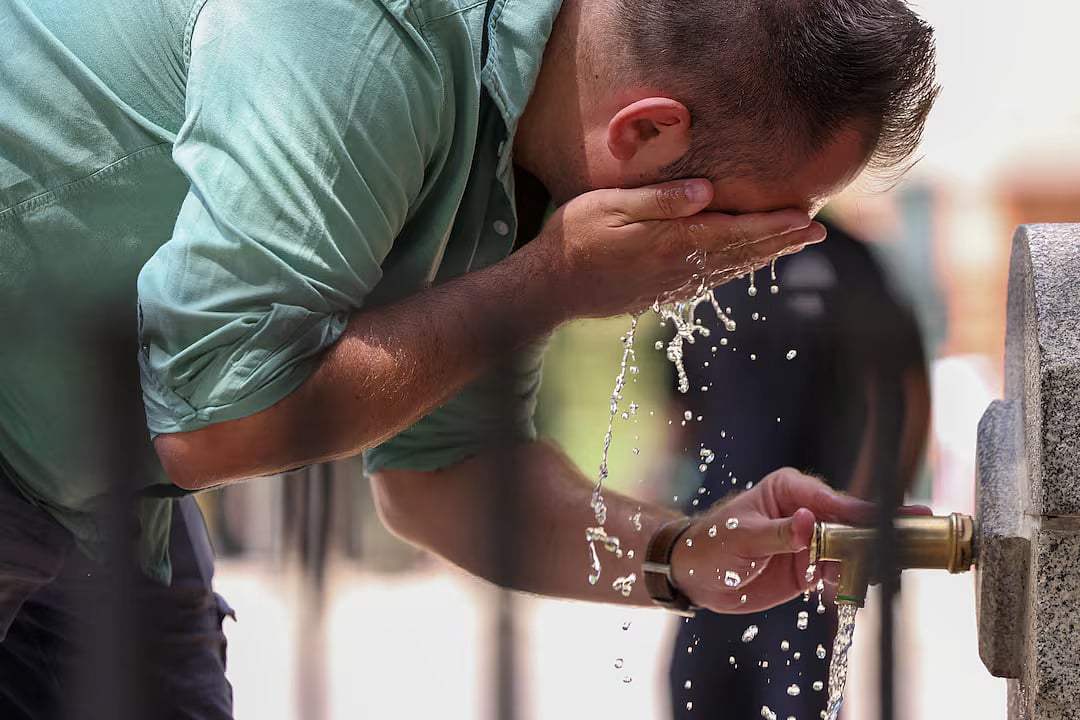 A man cools off at a fountain at Retiro park during a heatwave, in Madrid, Spain, 1 July 2025.