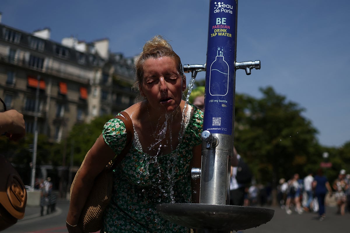 A woman cools off in a public fountain near the Place du Trocadero during high temperatures amid a heatwave in Paris, France, 27 June, 2026.