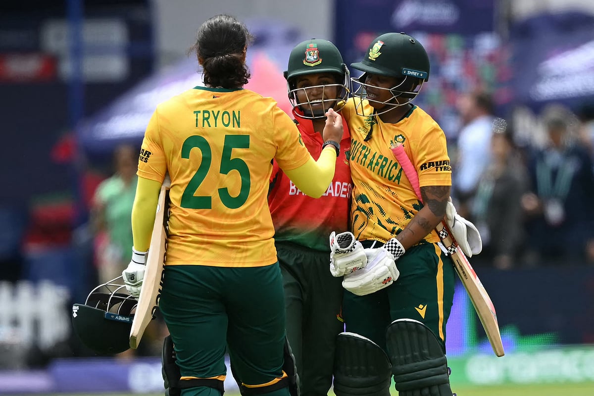 South Africa’s Chloe Tryon (L) and South Africa’s Sinalo Jafta (R) console Bangladesh’s captain Nigar Sultana (C) after the ICC Women’s T20 cricket world cup 2026 game between South Africa and Bangladesh, at Lord’s in London on 28 June 2026
