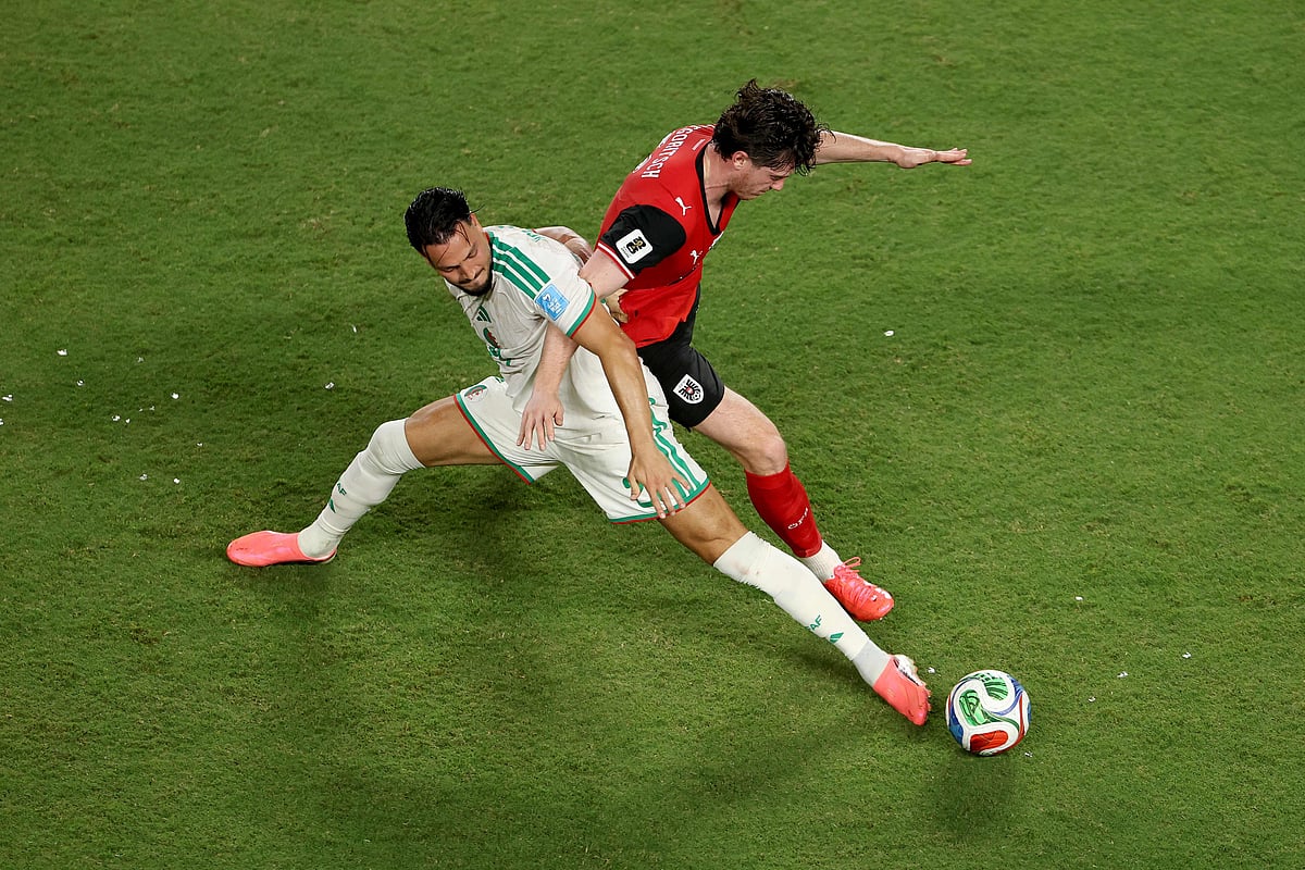 Michael Gregoritsch #11 of Austria competes for the ball against Ramy Bensebaini #21 of Algeria during the FIFA World Cup 2026 Group J match between Algeria and Austria at Kansas City Stadium on 27 June, 2026 in Kansas City, Missouri.